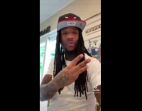 Guy sits on kitchen stove 