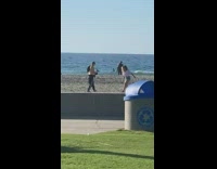 Girl walks down beach sand