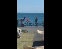 Woman red leggings photo shoot beach railings