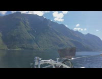 Green grass mountains ocean boat white bicycle 