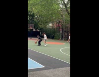 Police officer play basketball with guys at park