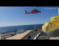 Red helicopter lifts person off cruise ship 