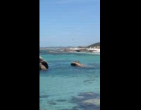 Woman lie down on rock drone above
