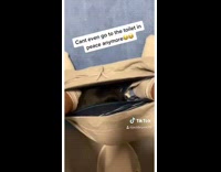 Cat lays down inside shorts guy toilet 