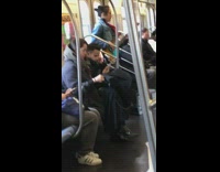 Man sings and plays bass guitar on subway train