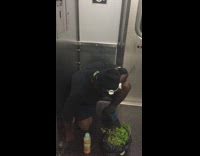 Man kneels on subway floor and shouts state names in alphabetical order