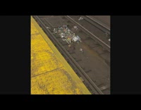 Trash pile on subway tracks surrounded by rats