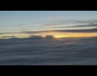 Sunset over clouds view from plane flight