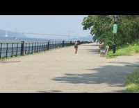 Lady dances in front of park bench for video 