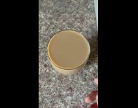 Coffee in a glass tapped to make a ripple inside