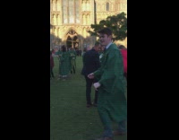 Guy green graduation gown backflips at school