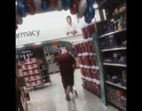 Guy purposely falls on stacked coolers store 