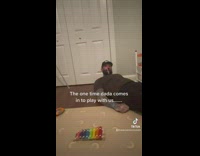 Dad playing on floor with baby 