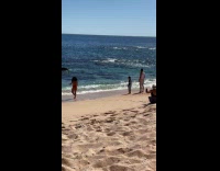 Woman in bikini handstand for beach photo