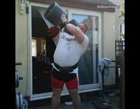 Guy lifts heavy dumbbell with one hand 