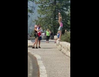 Blonde girl backless top stand ledge park