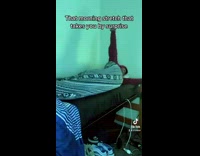 Guy in red hoodie stretching light changing room