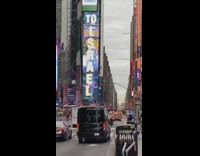 Guy Rides on Back of Mail Truck 