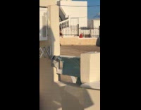 Woman see-thru dress dances over the fence