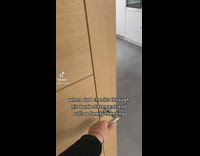 Two girls open door to dad at table waiting