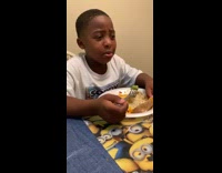 Boy cries when his mom makes him eat vegetables at dinner table