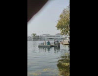 Woman teal gown spin on platform leaves thrown