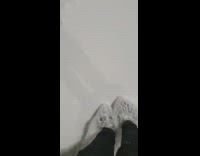 Filmer ice skates and slides on the snow