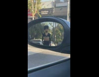 Black shirt girl walks car side mirror 