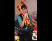 Guy wearing bacon costumer takes a hit out of juul and drinks shot of vodka