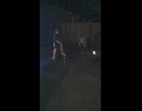 Barefoot guy hits orange ball hockey stick 