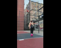 Girl attempts to touch basketball net 