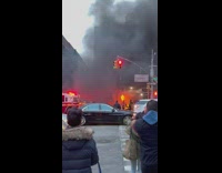 Massive fire from car accident at intersection into sidewalk