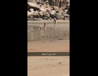 Girl bikini back crawl position beach rocky