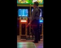 Man does gun tricks playing arcade game