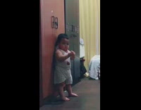 Cute chubby baby plays with clackers toy 