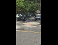 Black car backs up broken fire hydrant 