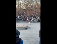 Skaters jump over man with lampshade on head