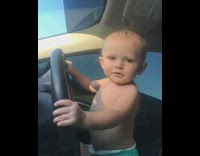 Baby in diapers holds onto steering wheel and dances to Pink in the car