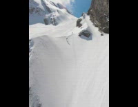 Guy snowboards down mountain and falls then recovers 