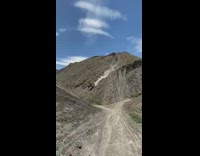 Guy falls off dirt bike going downhill 