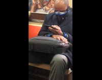 Guy on subway wears blue face mask 