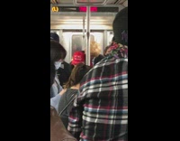 Man in bad trump costume on the train