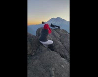 Man pushups on the edge of the cliff at sunrise