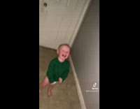 Collab BitchMP - Little boy in long sleeve green shirt in hallway laughing