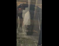 Person with table cloth on head is ghost of christmas on street