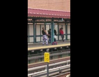 Man purple pants works out biceps with resistance band at train stop
