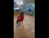 Baby boy carries cat around every where he goes 