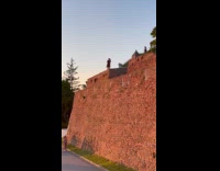 Couple hug on edge for sunset shoot