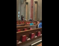 Man with red scarf tiktok dance inside the church