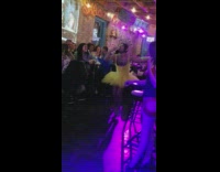 Drunk guy wears a yellow ballerina dress and high heels at a bar and deep throats a banana
